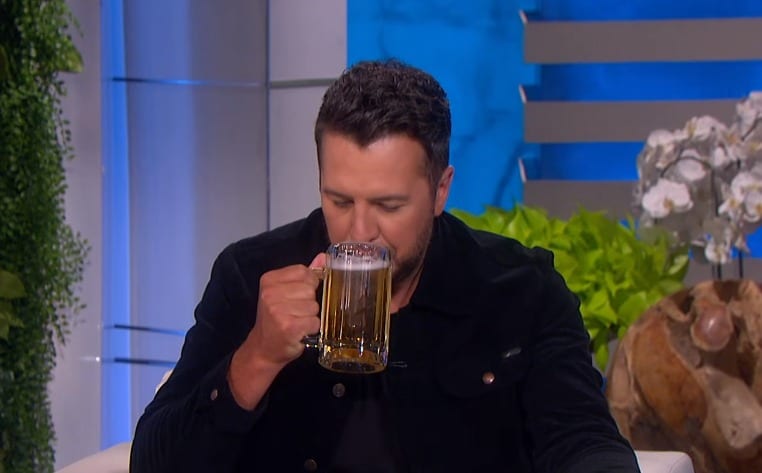 Luke Bryan drinking from a glass
