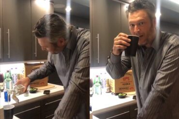 Blake Shelton holding a cup of coffee next to a man in a kitchen