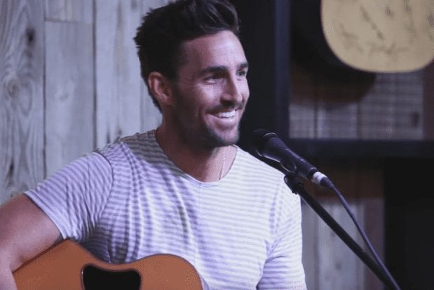 Jake Owen sitting in front of a microphone