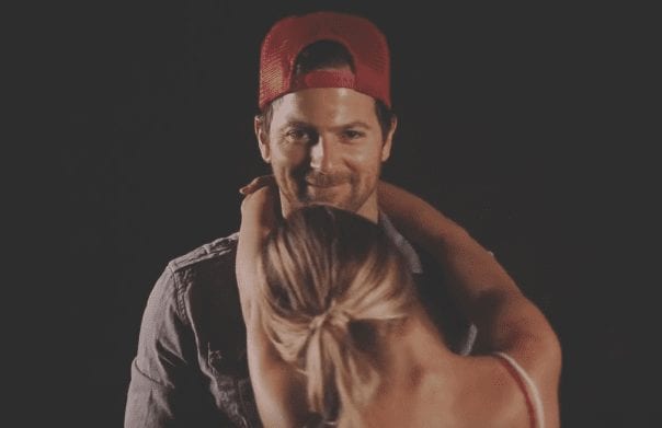 Kip Moore with a beard and a woman with a hat