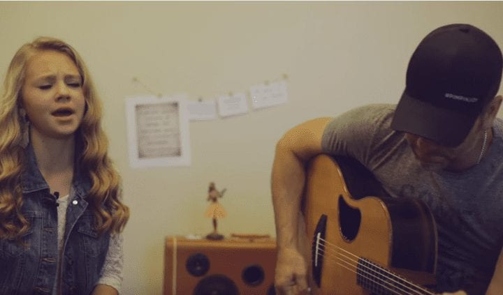 A man and a woman playing guitar