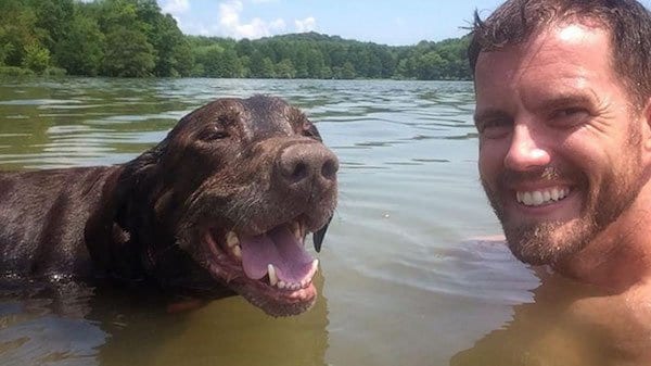 A man and a dog in a lake