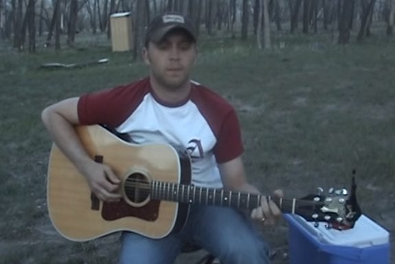A person sitting on a guitar