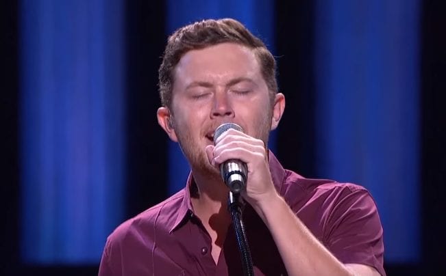 Scotty McCreery singing into a microphone
