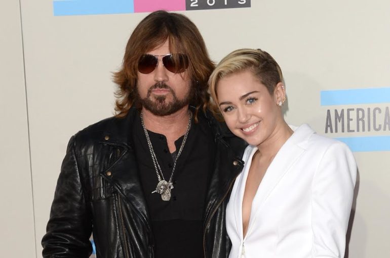 Billy Ray Cyrus, Miley Cyrus posing for a picture