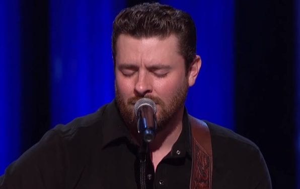 Chris Young with a beard and a microphone in front of him