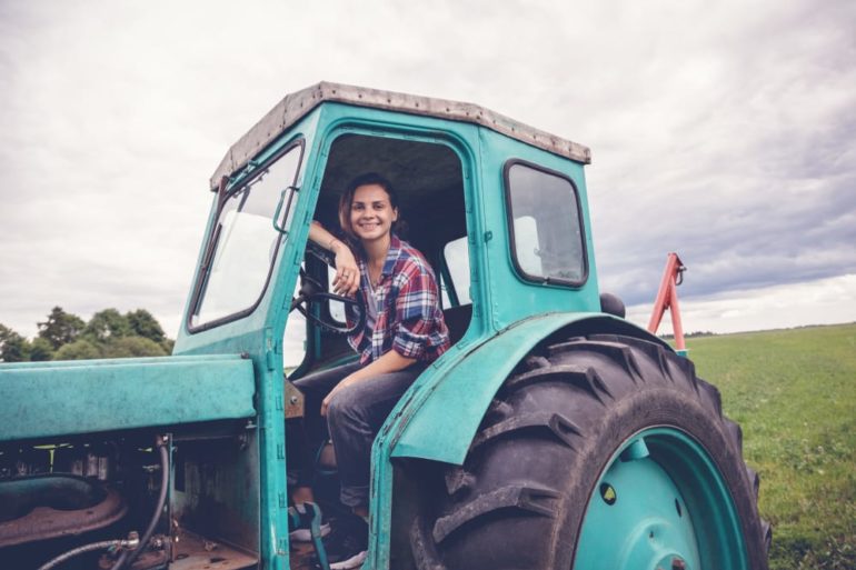 A person sitting on a green tractor