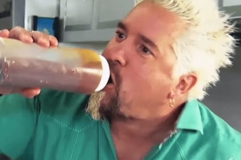 Guy Fieri drinking from a bottle