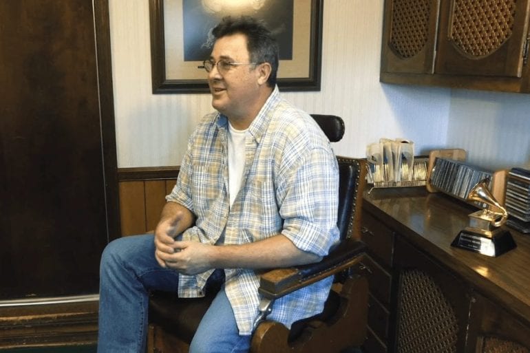 Vince Gill sitting in a chair