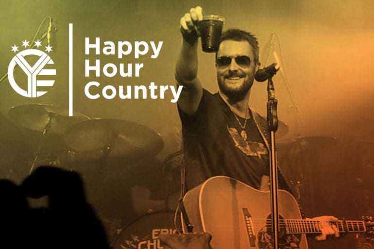 Eric Church with a microphone and a drum set in front of him