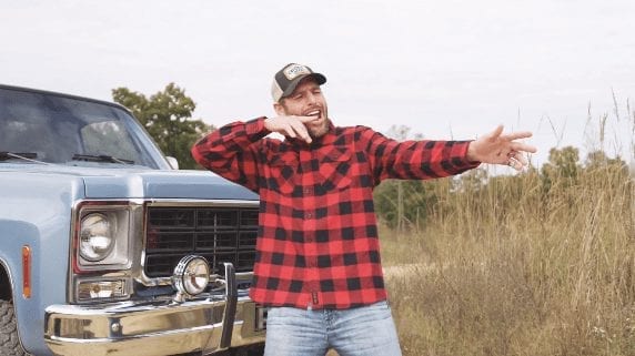 A man standing next to a truck