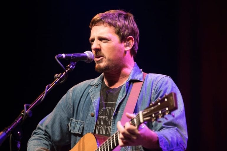 Sturgill Simpson playing a guitar