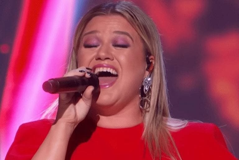 Kelly Clarkson singing into a microphone