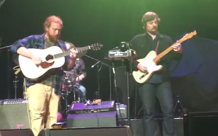 A group of men playing guitars