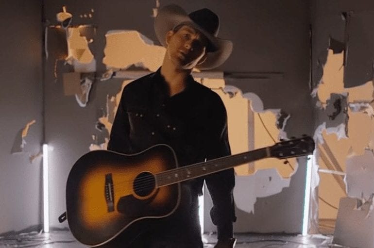 A person in a cowboy hat and a guitar