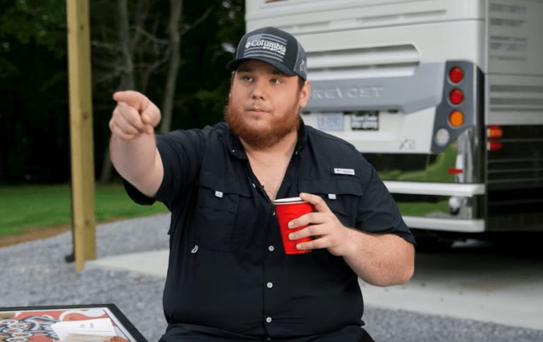 Luke Combs holding a red cup