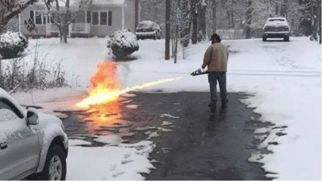 A person standing next to a fire