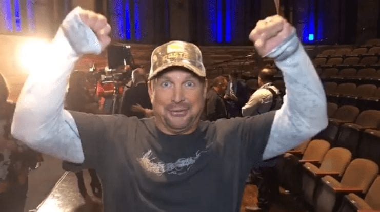 Garth Brooks with his hand up