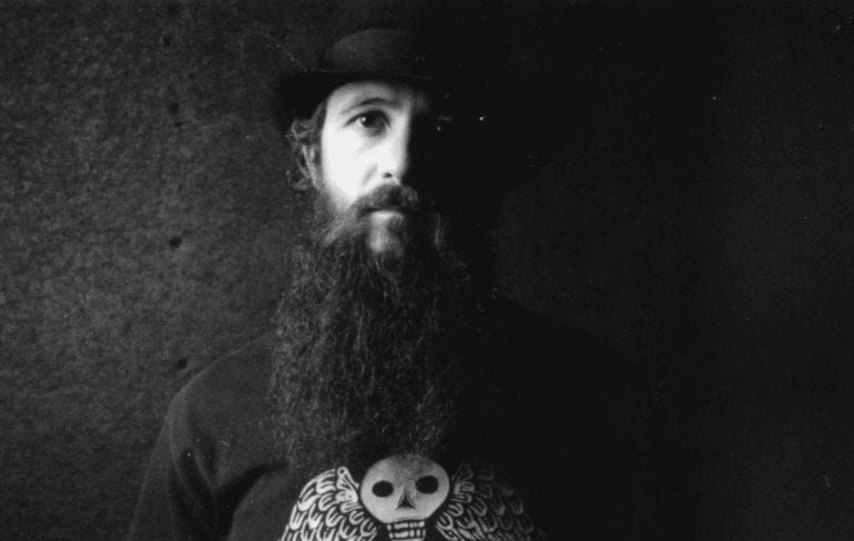 A man with a long beard and a hat