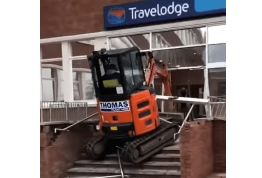 A person standing on a ladder on a train