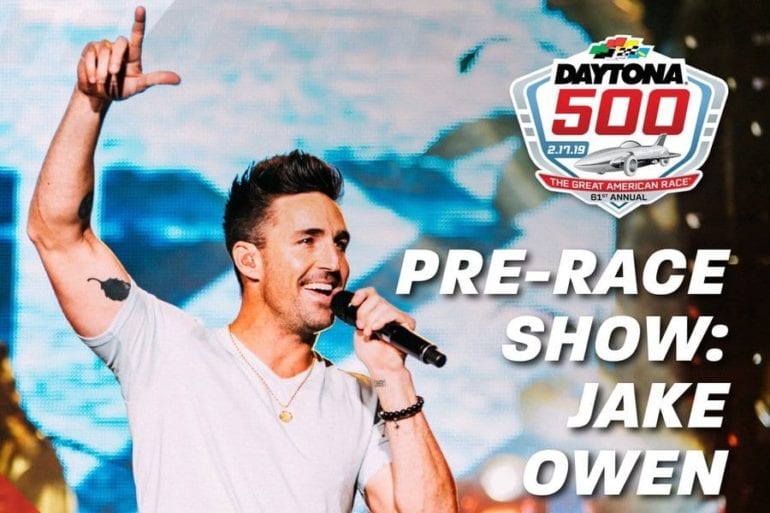 Jake Owen holding a microphone and pointing