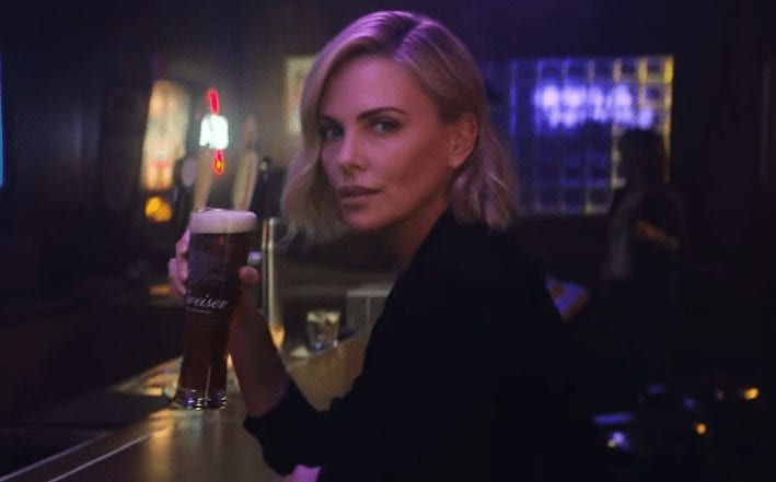 Charlize Theron sitting at a table