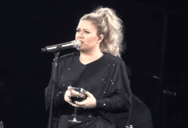 Kelly Clarkson holding a glass of wine