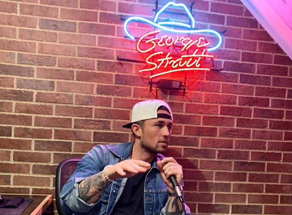 Michael Ray sitting on a chair