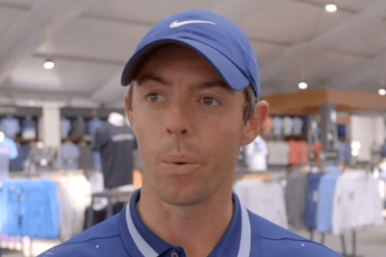 Rory McIlroy wearing a blue shirt and blue hat