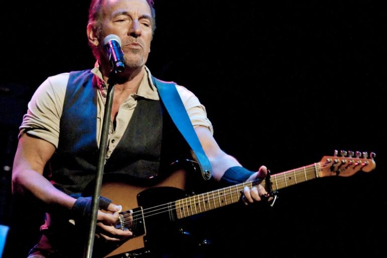 Bruce Springsteen playing a guitar