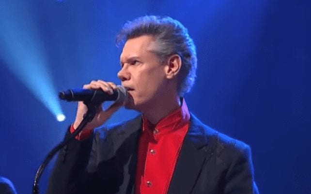 Randy Travis singing into a microphone