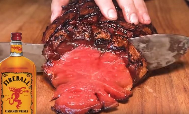 A hand holding a steak