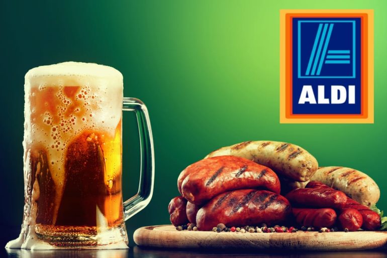 A glass of beer next to a plate of sausages and sausages