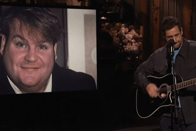 Chris Farley holding a microphone