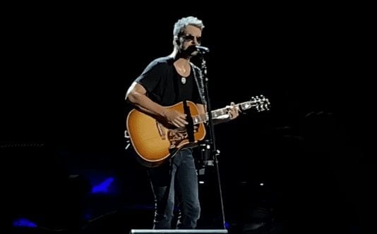 A man playing a guitar on a stage