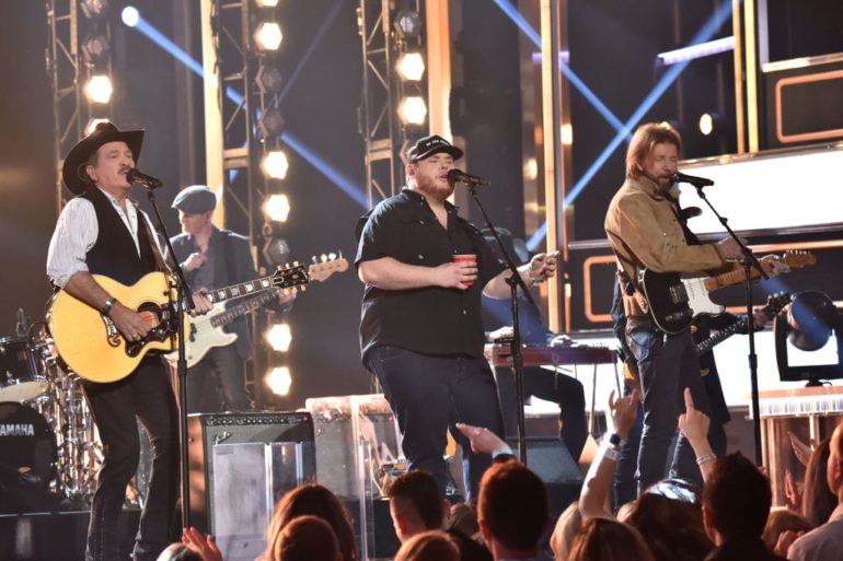 Luke Combs, Ronnie Dunn et al. on a stage