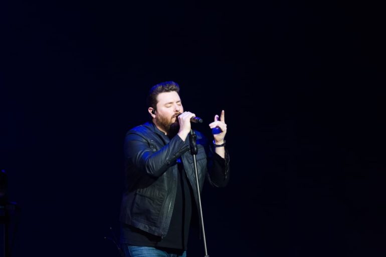 Chris Young singing into a microphone