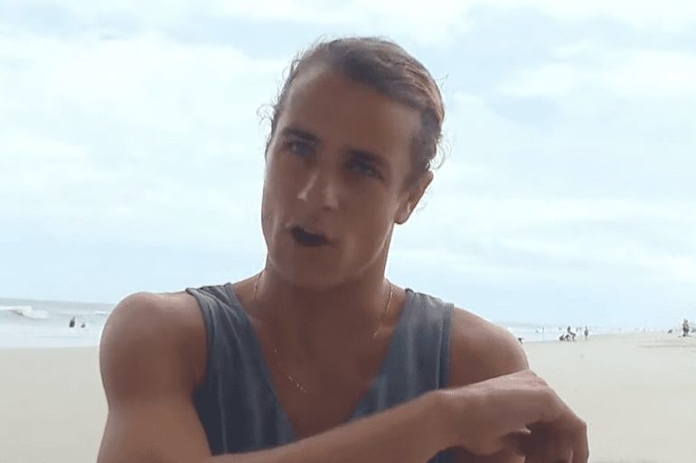 A man with his mouth open on a beach