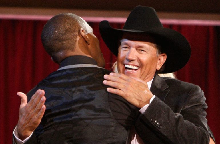 George Strait in a suit laughing
