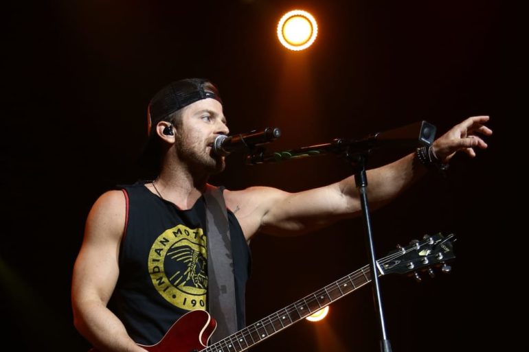 Kip Moore singing into a microphone
