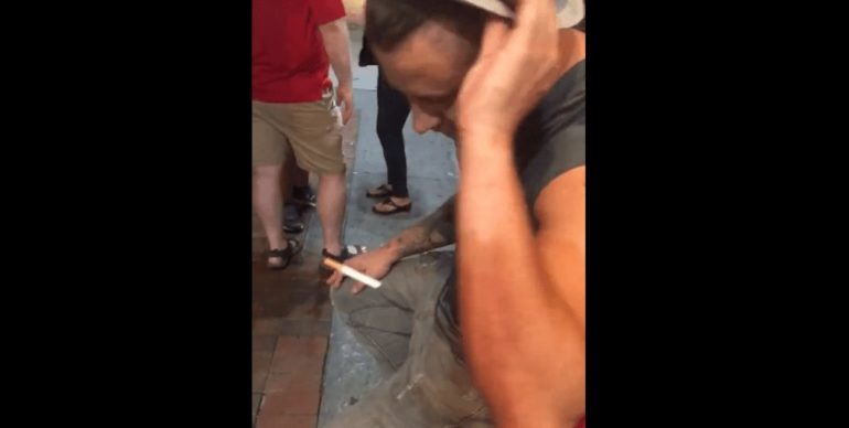 A man holding a cigarette
