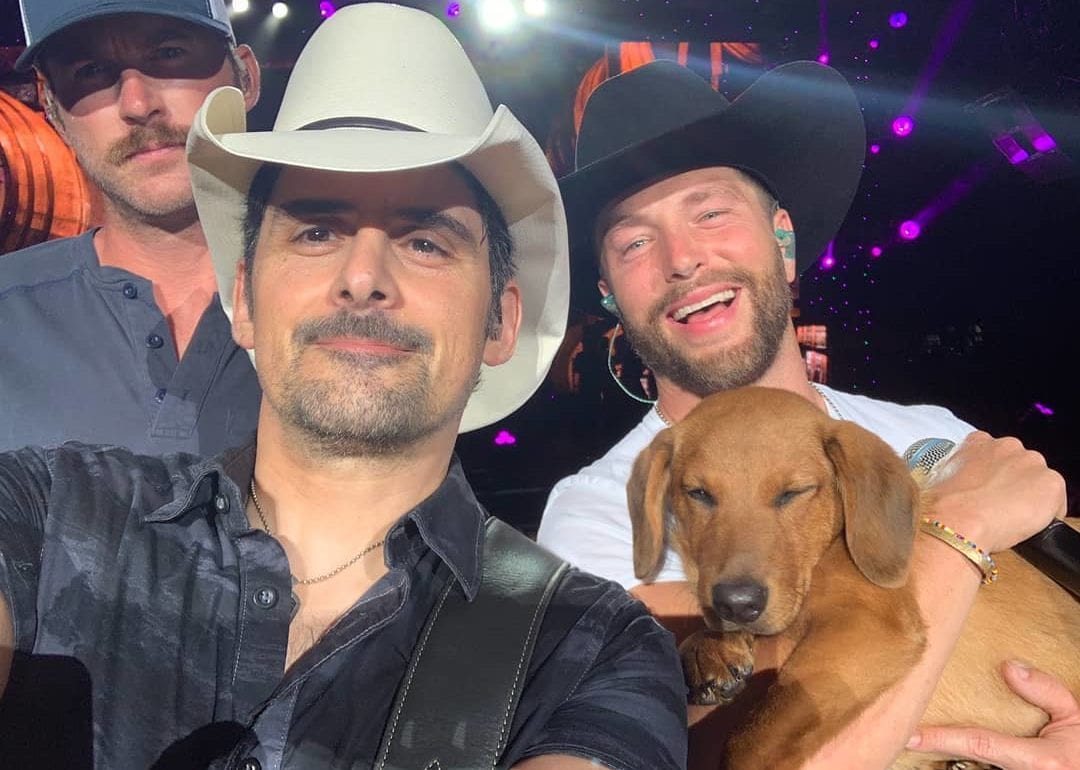 Brad Paisley and a dog posing for the camera