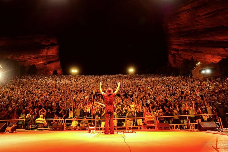A person on a stage with a crowd watching