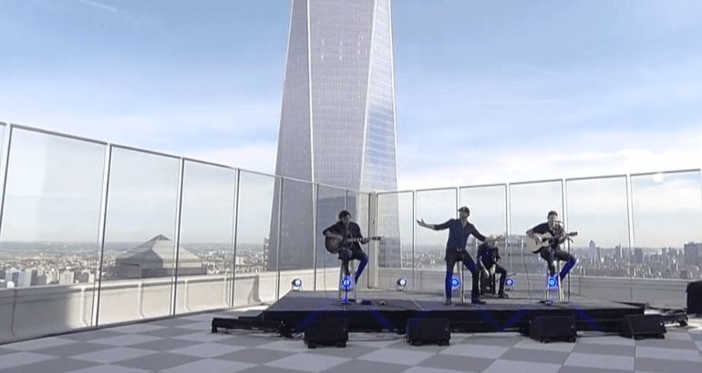 A group of people riding skateboards on a rooftop