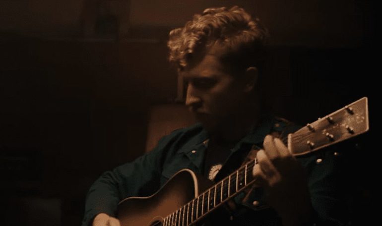 A man playing a guitar