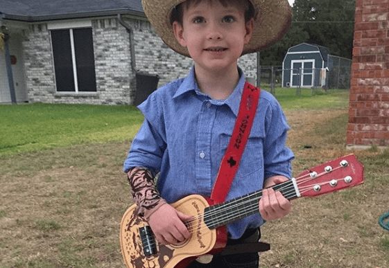 A boy holding a guitar