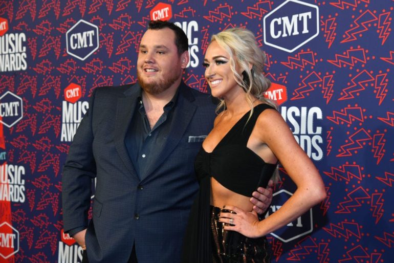 Luke Combs and woman posing for a picture