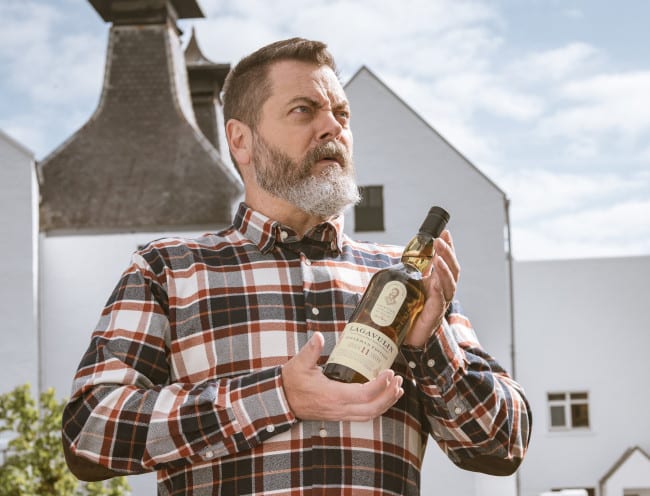 Nick Offerman holding a bottle of alcohol
