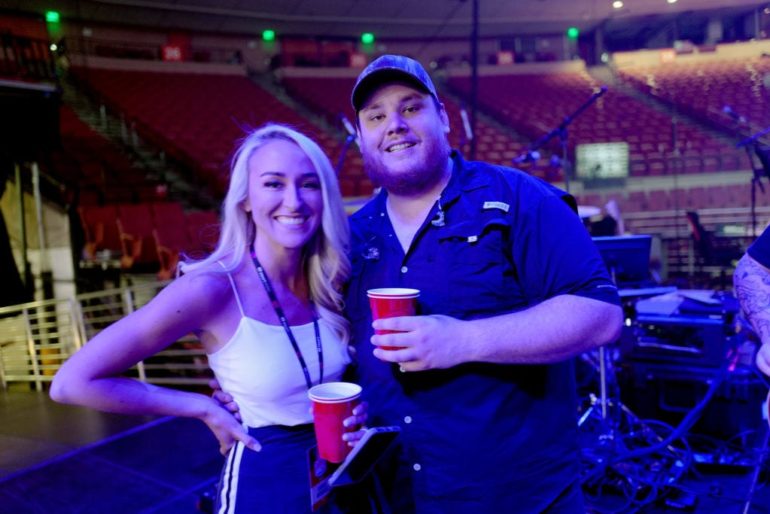 Luke Combs and woman holding cups