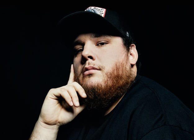 Luke Combs with a beard and a hat
